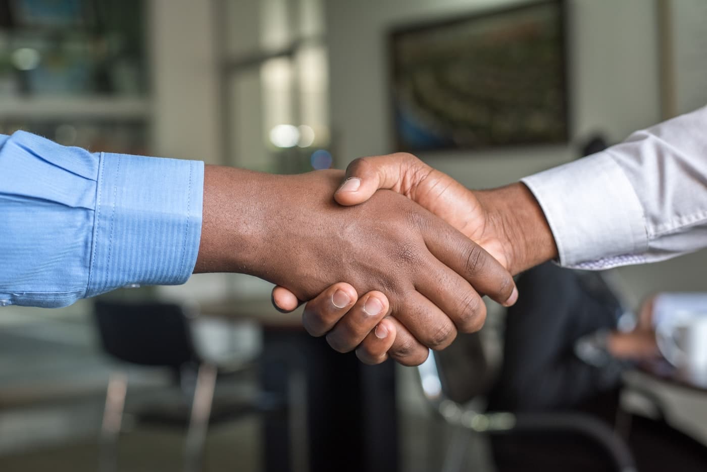 Professional handshake representing provider enrollment and network partnership