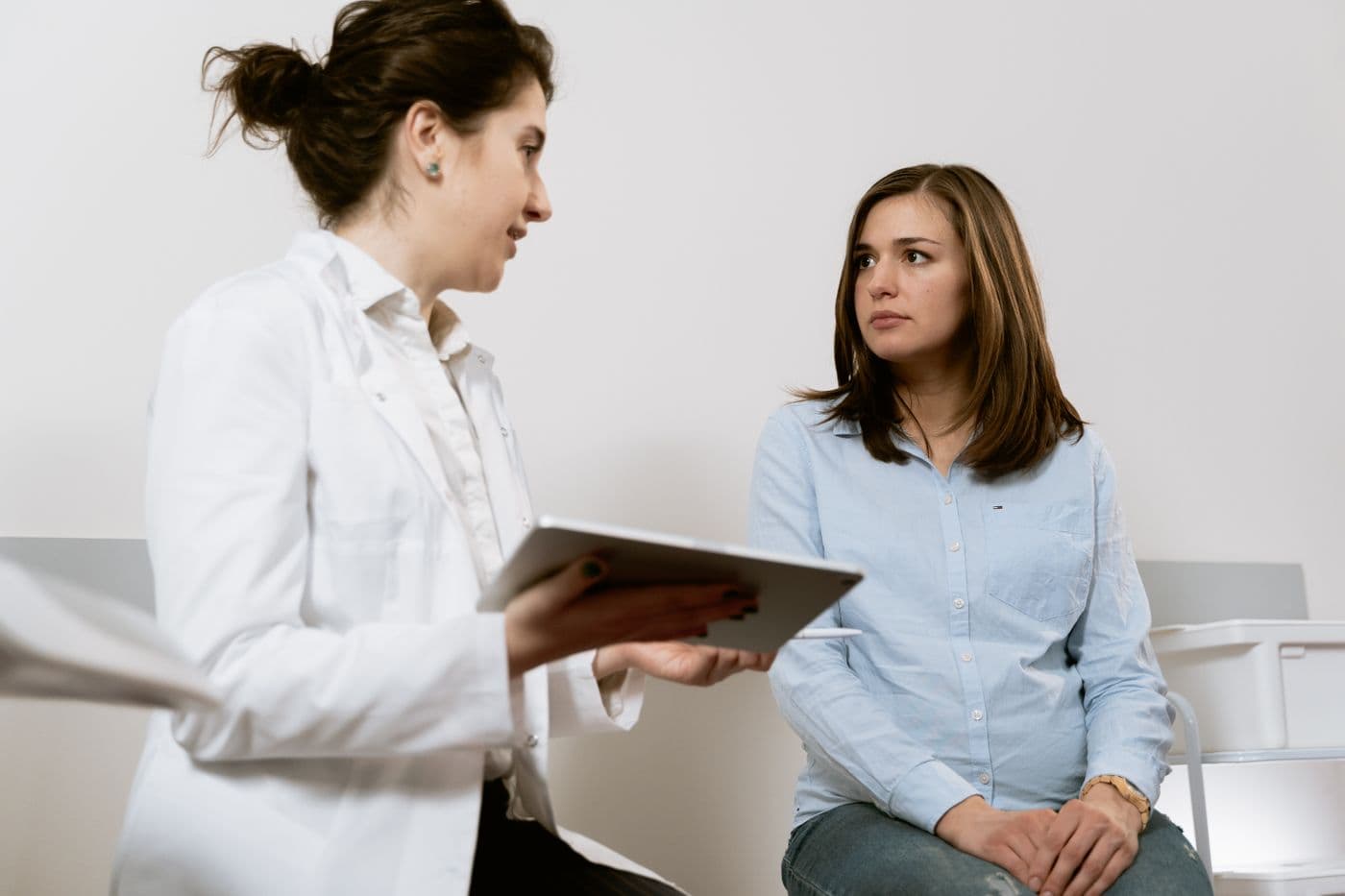 Clinician reviewing documentation with a patient using a digital tablet