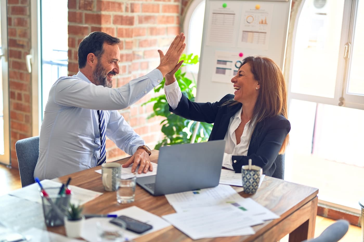 Operations teammates collaborating on revenue and workflow results in a bright office